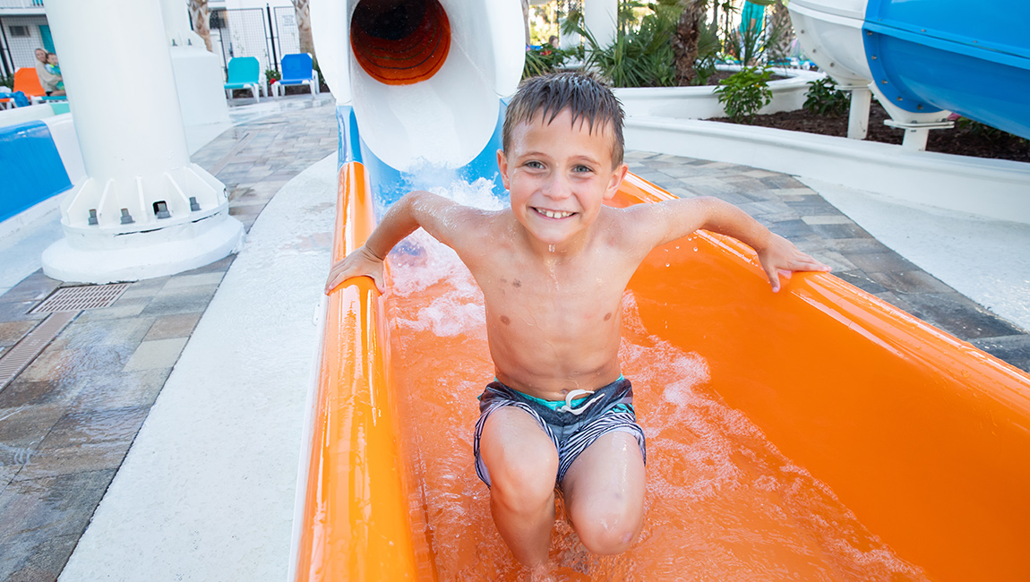 Boy coming out of the slide