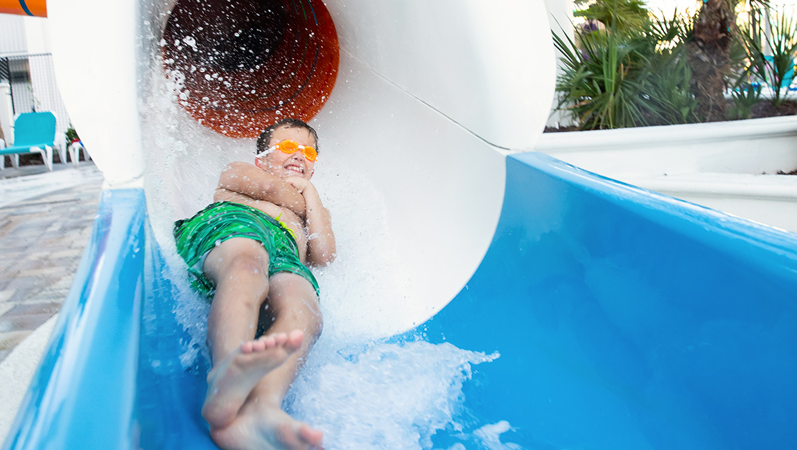 Boy coming down the slide