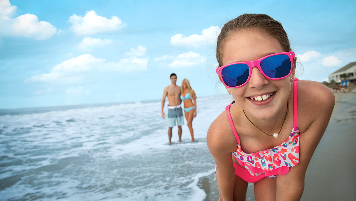 Girl wearing sunglasses at the beach