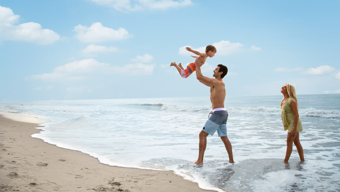 Father holding up son in Myrtle Beach